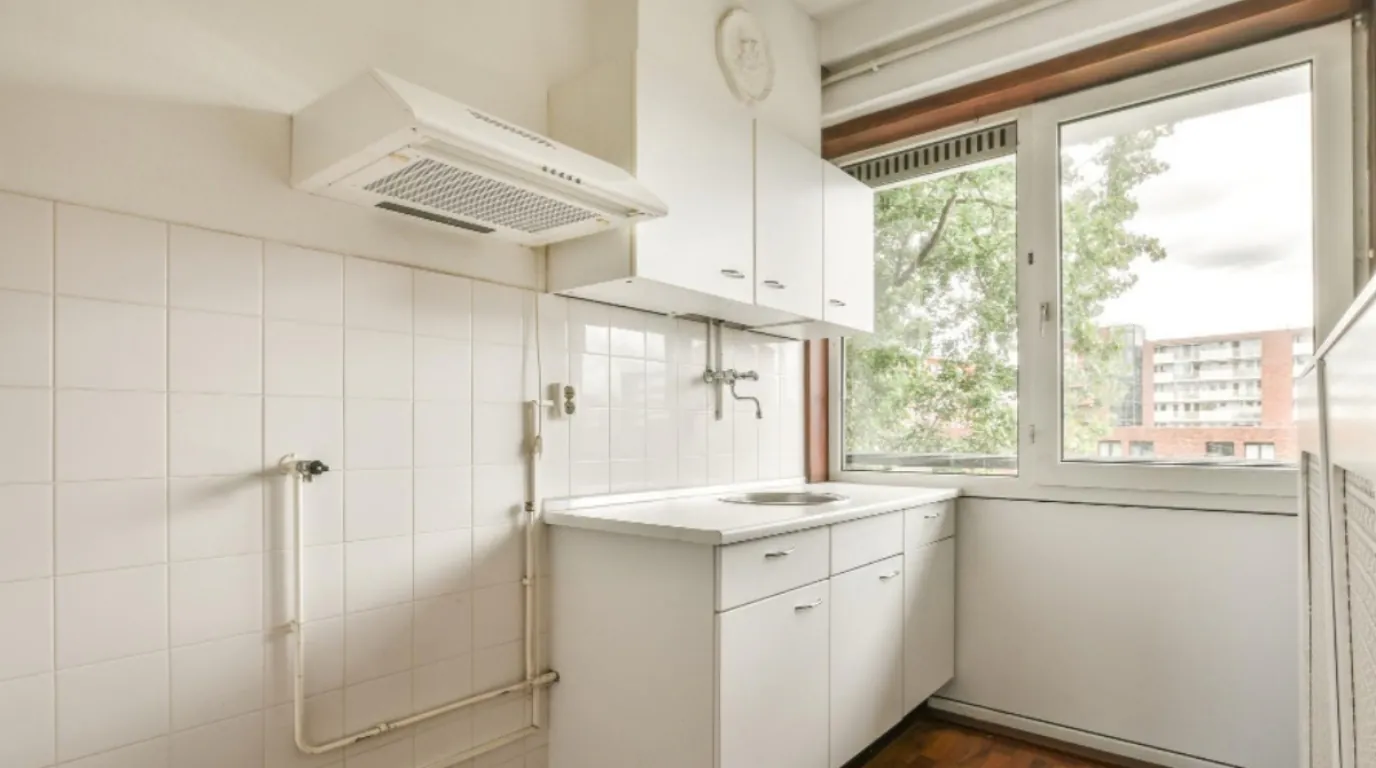 corner-fan-small-kitchen-singapore.jpg Corner-mounted fan installed above a compact HDB kitchen counter